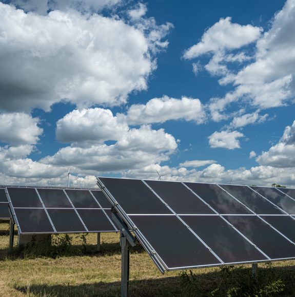 The solar panels used for renewable energy on the field under the sky full of clouds